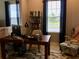 Comfortable home office featuring a wooden desk, decorative chair, and built-in shelving at 15708 Orange Harvest Loop, Winter Garden, FL 34787