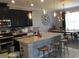Modern kitchen with stainless appliances, a spacious island, and barstool seating at 15708 Orange Harvest Loop, Winter Garden, FL 34787