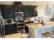 Well-equipped kitchen with dark cabinetry, granite countertops, and stainless appliances at 15708 Orange Harvest Loop, Winter Garden, FL 34787