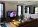Inviting living room with a modern entertainment center, comfortable seating, and natural lighting at 15708 Orange Harvest Loop, Winter Garden, FL 34787