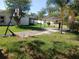 Backyard with carport, basketball hoop, palm tree, and green grass at 1100 Peak Cir, Deltona, FL 32738