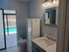 Bathroom with new marble vanity top and mirror, toilet, and glass doors to pool at 1100 Peak Cir, Deltona, FL 32738