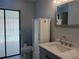 Updated bathroom with vanity, toilet, and frosted-glass-enclosed shower or pool entrance at 1100 Peak Cir, Deltona, FL 32738