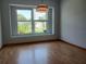 Bright dining room featuring laminate flooring, a large window, and neutral paint at 1100 Peak Cir, Deltona, FL 32738