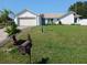 Charming single Gathering home featuring a well-manicured lawn and attached garage at 1100 Peak Cir, Deltona, FL 32738