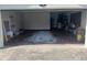 Open garage with empty parking space and disorganized storage areas at 1100 Peak Cir, Deltona, FL 32738