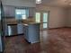 Bright eat-in kitchen featuring an island with gray cabinets, stainless steel appliances, and tile flooring at 1100 Peak Cir, Deltona, FL 32738