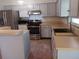 Kitchen with stainless steel appliances, light gray cabinets, and a window over the sink at 1100 Peak Cir, Deltona, FL 32738