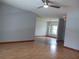 Open floor plan living room showcasing hardwood floors, neutral walls, and a view into the kitchen at 1100 Peak Cir, Deltona, FL 32738