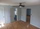 Main bedroom with ceiling fan and doors to both the bathroom and closet at 1100 Peak Cir, Deltona, FL 32738