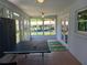 Enclosed patio with tile floor, ping pong table, sliding glass doors, and colorful rug at 1100 Peak Cir, Deltona, FL 32738