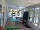 Enclosed patio with tile floor and glass windows and doors showing view of the backyard at 1100 Peak Cir, Deltona, FL 32738