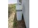 Close-up of Flow-Pur water softener sitting outside next to white wall at 1100 Peak Cir, Deltona, FL 32738