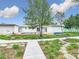 A spacious backyard with a pool, green grass, and a walkway at 116 7Th St, Winter Haven, FL 33880
