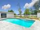 A vibrant backyard pool surrounded by well-maintained landscaping and lush greenery at 116 7Th St, Winter Haven, FL 33880