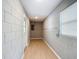 An unfinished basement features painted cinder block walls, vinyl floors, a window, and a utility access door at 116 7Th St, Winter Haven, FL 33880
