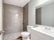 Bathroom featuring tiled shower, modern vanity, and stone pebble flooring at 116 7Th St, Winter Haven, FL 33880