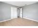 Bedroom features include wood flooring, closet with white doors and neutral gray walls at 116 7Th St, Winter Haven, FL 33880