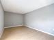 A bedroom showcasing the spacious layout and wood flooring and neutral gray color palette at 116 7Th St, Winter Haven, FL 33880