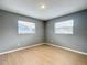Bedroom showcasing natural light with wood flooring, gray paint, and two windows at 116 7Th St, Winter Haven, FL 33880