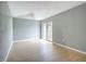 Open-concept bedroom area boasts new floors and sliding glass door at 116 7Th St, Winter Haven, FL 33880