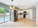 Modern kitchen featuring stainless steel appliances, white cabinets, and sliding glass doors to the pool area at 116 7Th St, Winter Haven, FL 33880