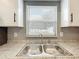 Kitchen features a stainless steel sink and granite countertops at 116 7Th St, Winter Haven, FL 33880