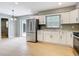 A kitchen with stainless steel appliances, white cabinets, granite countertops, wooden floors, and grey walls at 116 7Th St, Winter Haven, FL 33880