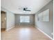 Bright living room featuring light wood floors, neutral walls, and contemporary ceiling fan at 116 7Th St, Winter Haven, FL 33880