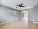 Bright living room featuring light wood floors, neutral walls, and contemporary ceiling fan at 116 7Th St, Winter Haven, FL 33880