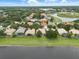 Aerial view of waterfront community with lush lawns and mature landscaping offers a glimpse of serene lakeside living at 1266 Saint Albans Loop, Lake Mary, FL 32746