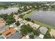 Aerial view showcases a community with waterfront homes, lush greenery, and serene lakes, offering a picturesque setting at 1266 Saint Albans Loop, Lake Mary, FL 32746
