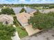 Aerial view of a well-maintained home with a tile roof, manicured lawn, mature landscaping, and a water view at 1266 Saint Albans Loop, Lake Mary, FL 32746