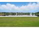 Picturesque backyard with lush green grass and serene water views provides a tranquil and inviting outdoor space at 1266 Saint Albans Loop, Lake Mary, FL 32746