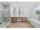 Bright bathroom with double vanity, soaking tub, and glass-enclosed shower at 1266 Saint Albans Loop, Lake Mary, FL 32746