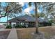 Exterior of a charming clubhouse with a lake view featuring lush greenery and sidewalk access, ideal for community gatherings at 1266 Saint Albans Loop, Lake Mary, FL 32746