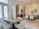 Open-concept dining area with a view of the living room, modern furniture, and plenty of natural light at 1266 Saint Albans Loop, Lake Mary, FL 32746