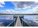 Scenic view of a dock extending onto a beautiful lake under a partly cloudy sky at 1266 Saint Albans Loop, Lake Mary, FL 32746