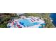 Aerial view of community pool with many chairs, umbrellas, and palm trees. A great place to relax and soak up the sun at 1266 Saint Albans Loop, Lake Mary, FL 32746