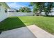 Spacious backyard with lush green grass, a concrete patio, and white vinyl fence at 1340 Continental Dr, Daytona Beach, FL 32117