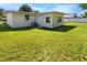 Exterior view of home showcasing well-maintained lawn and backyard with freshly painted white exterior at 1340 Continental Dr, Daytona Beach, FL 32117