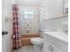 Cozy bathroom featuring a shower-tub combo with tiled walls and a white vanity, blending functionality and style at 1340 Continental Dr, Daytona Beach, FL 32117