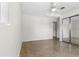 Bedroom features terrazzo floors, a ceiling fan, a mirrored closet, and natural light, ideal for relaxation at 1340 Continental Dr, Daytona Beach, FL 32117