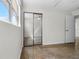 Bedroom featuring terrazzo floors, large mirrored closet, window, and ceiling fan, providing ample space and comfort at 1340 Continental Dr, Daytona Beach, FL 32117