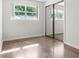 Bright bedroom with terrazzo floors, closet with mirrored sliding doors, and a window providing natural light at 1340 Continental Dr, Daytona Beach, FL 32117