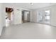 Open bonus room features painted floors, a ceiling light, and access to the garage, kitchen, and backyard at 1340 Continental Dr, Daytona Beach, FL 32117