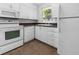 Clean, white kitchen featuring modern appliances, ample cabinet space, and a window for natural light at 1340 Continental Dr, Daytona Beach, FL 32117
