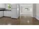 Bright kitchen featuring white cabinets, appliances, and seamless access to the adjacent living area at 1340 Continental Dr, Daytona Beach, FL 32117