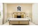 Bright bedroom with rattan bed frame, side tables with lamps and neutral walls at 1365 Inkberry Cir, Deland, FL 32720