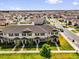 Aerial view of newly built townhomes with well-manicured lawns in a large neighborhood at 1555 Dawnview Way, Kissimmee, FL 34744